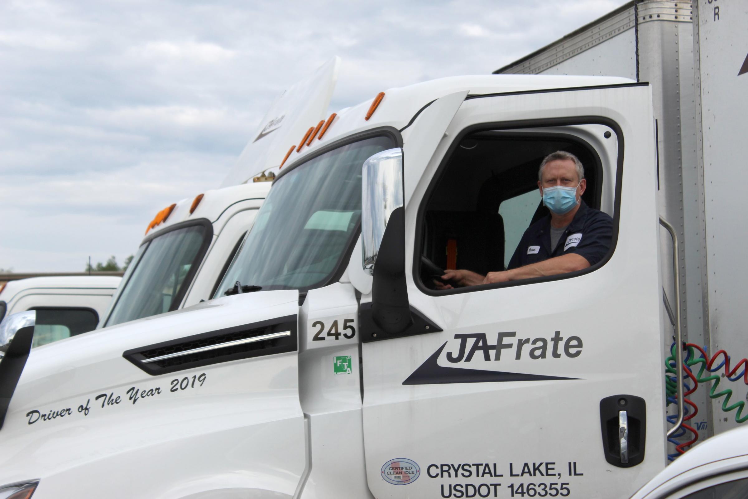 Illinois truck driver at JA Frate wearing a mask in his truck